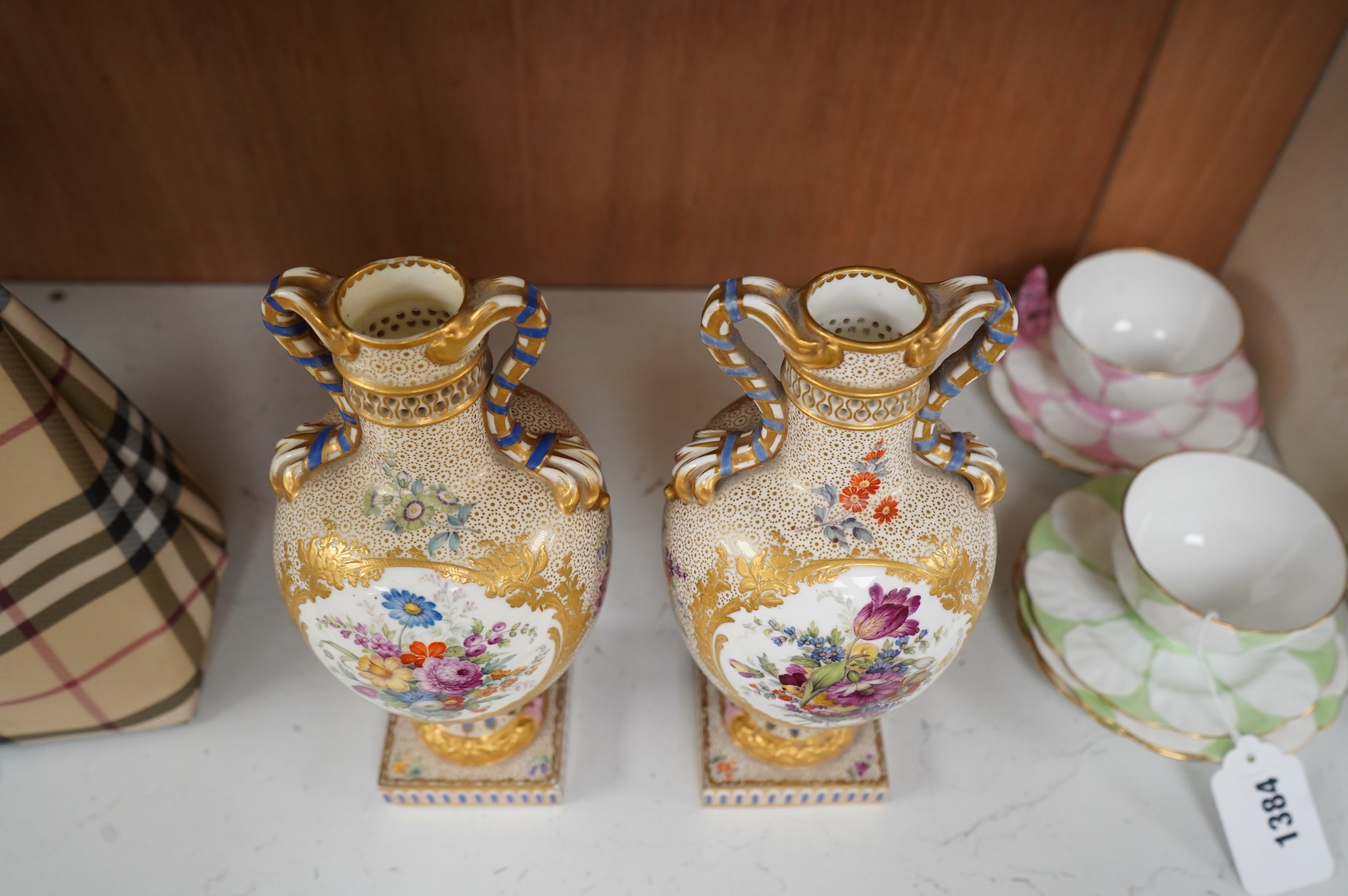 A pair of 19th century Sevres style porcelain vases hand painted with flowers, 22cm high